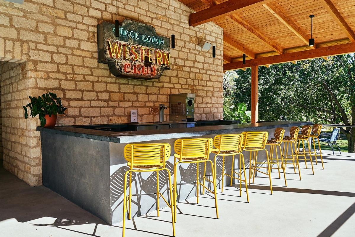 a group of yellow chairs in front of a brick building
