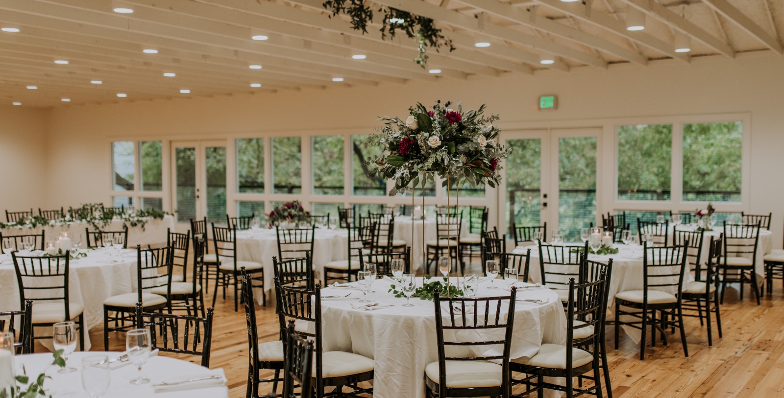 a group of tables with white cloths and flowers