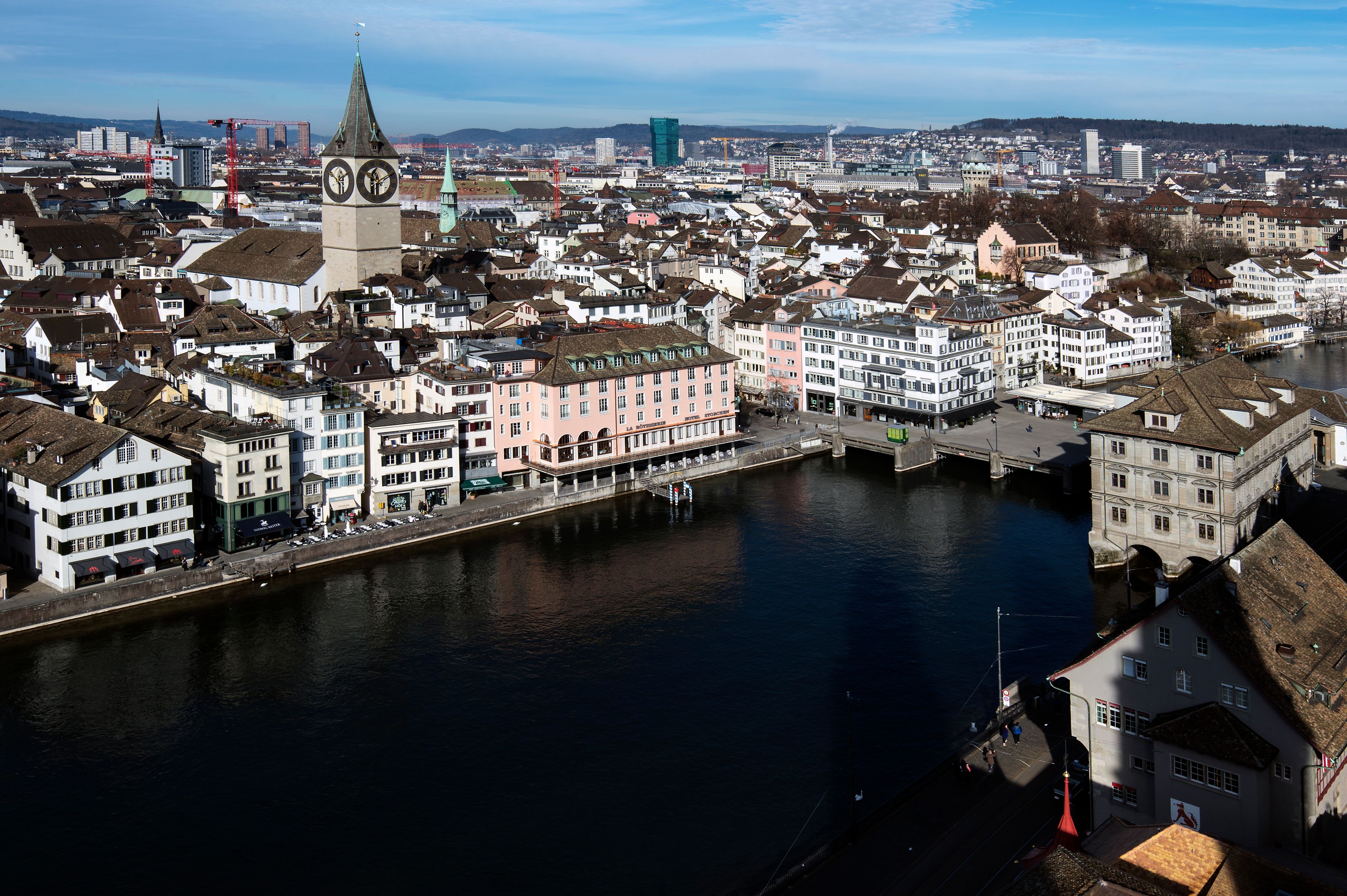 a city with a clock tower and a river