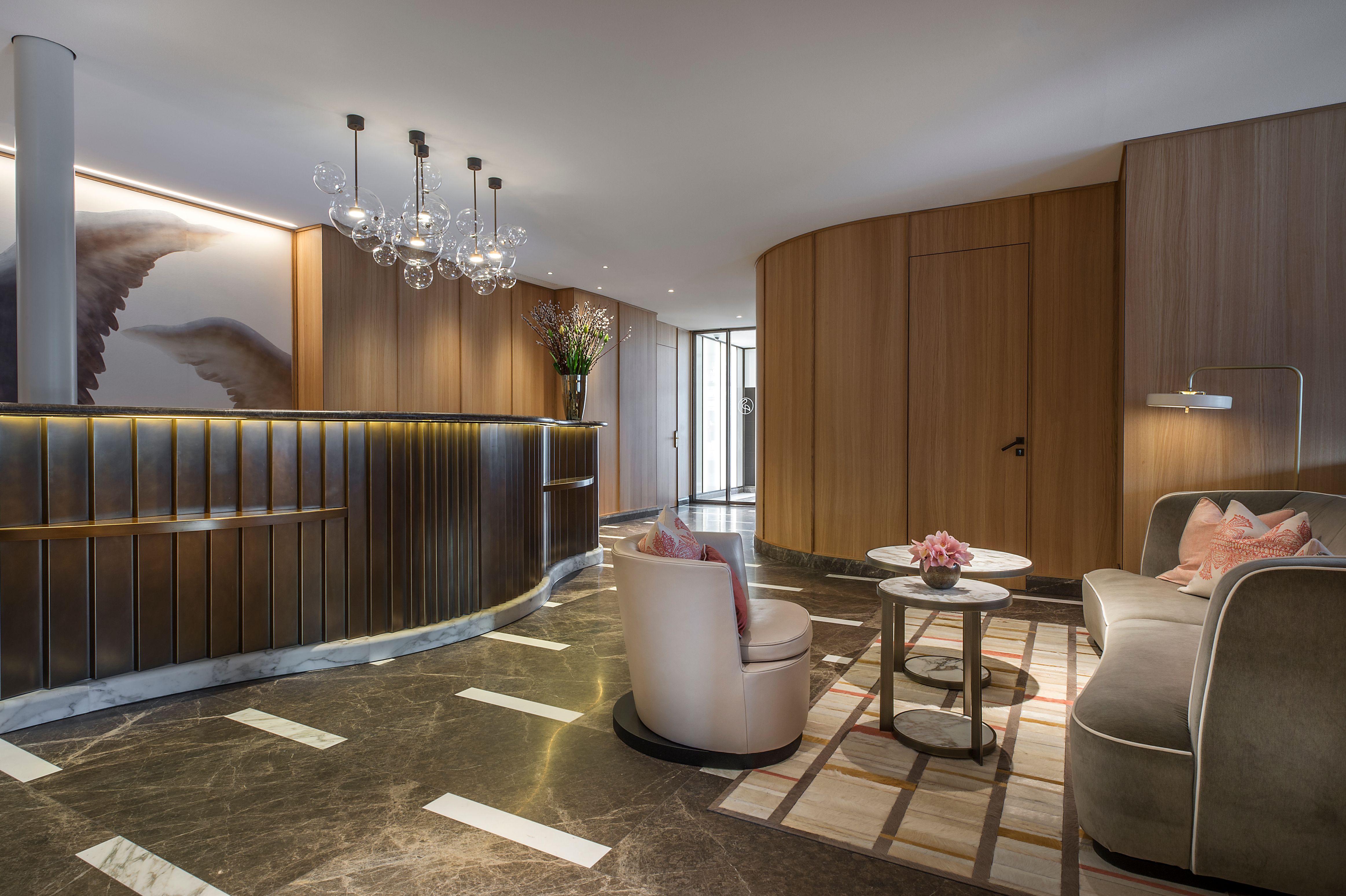 a lobby with a reception desk and chairs