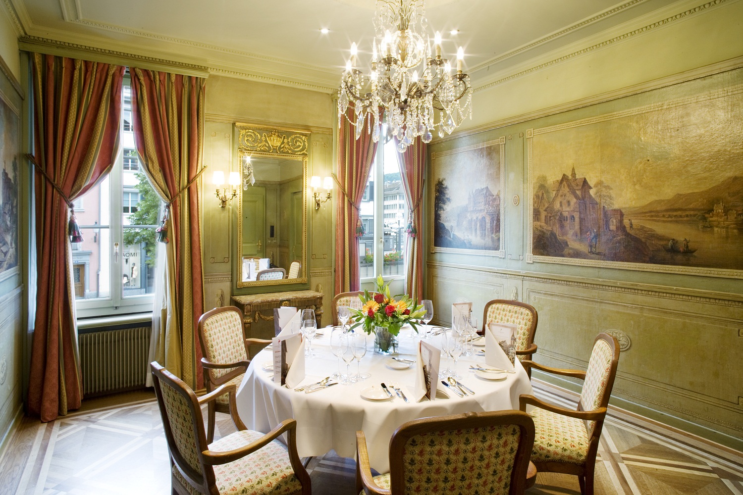 a dining room with a chandelier and table set