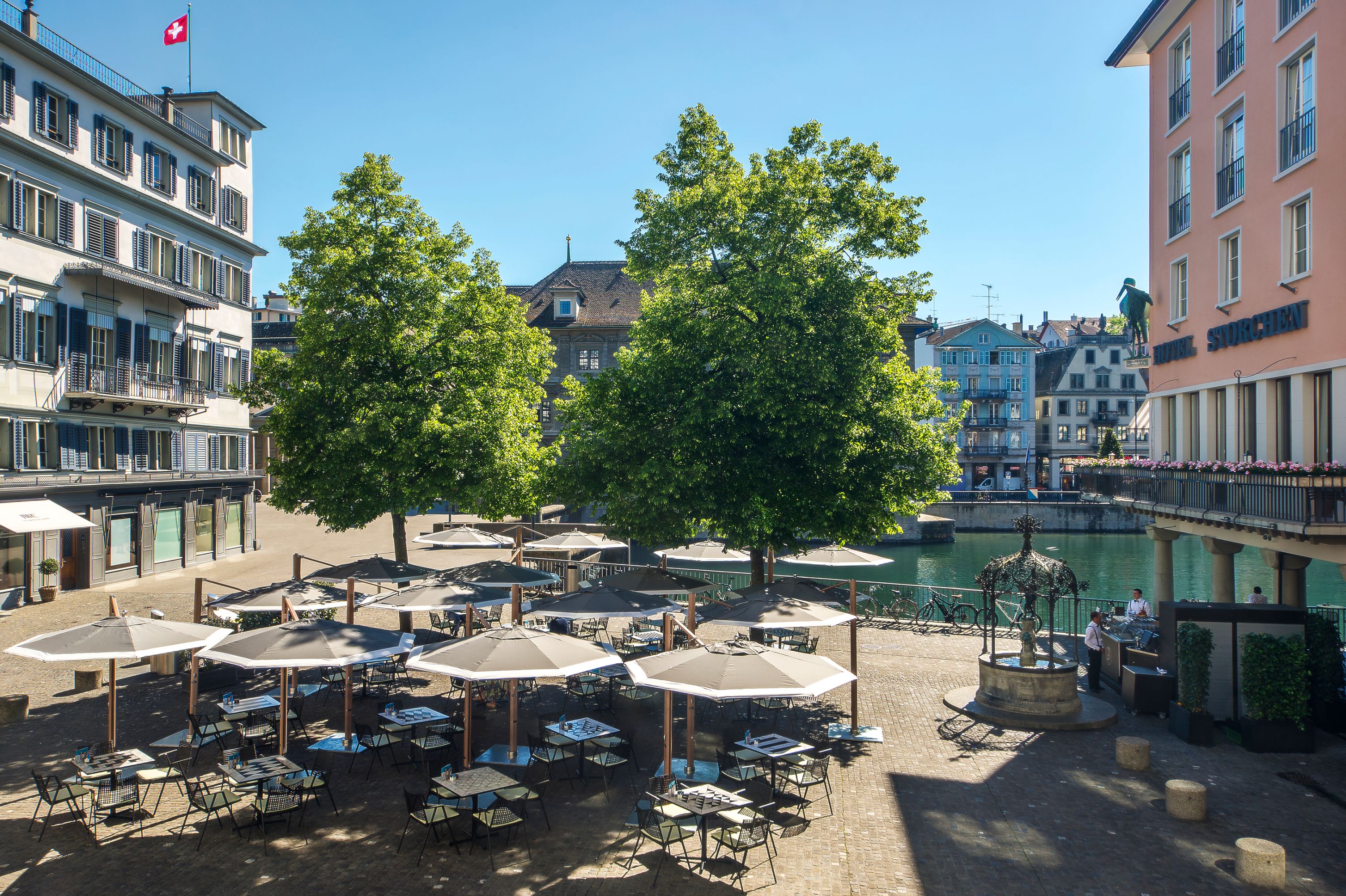 a group of tables and umbrellas in a city