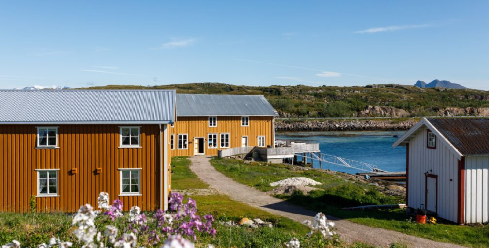 a yellow and orange building next to a body of water