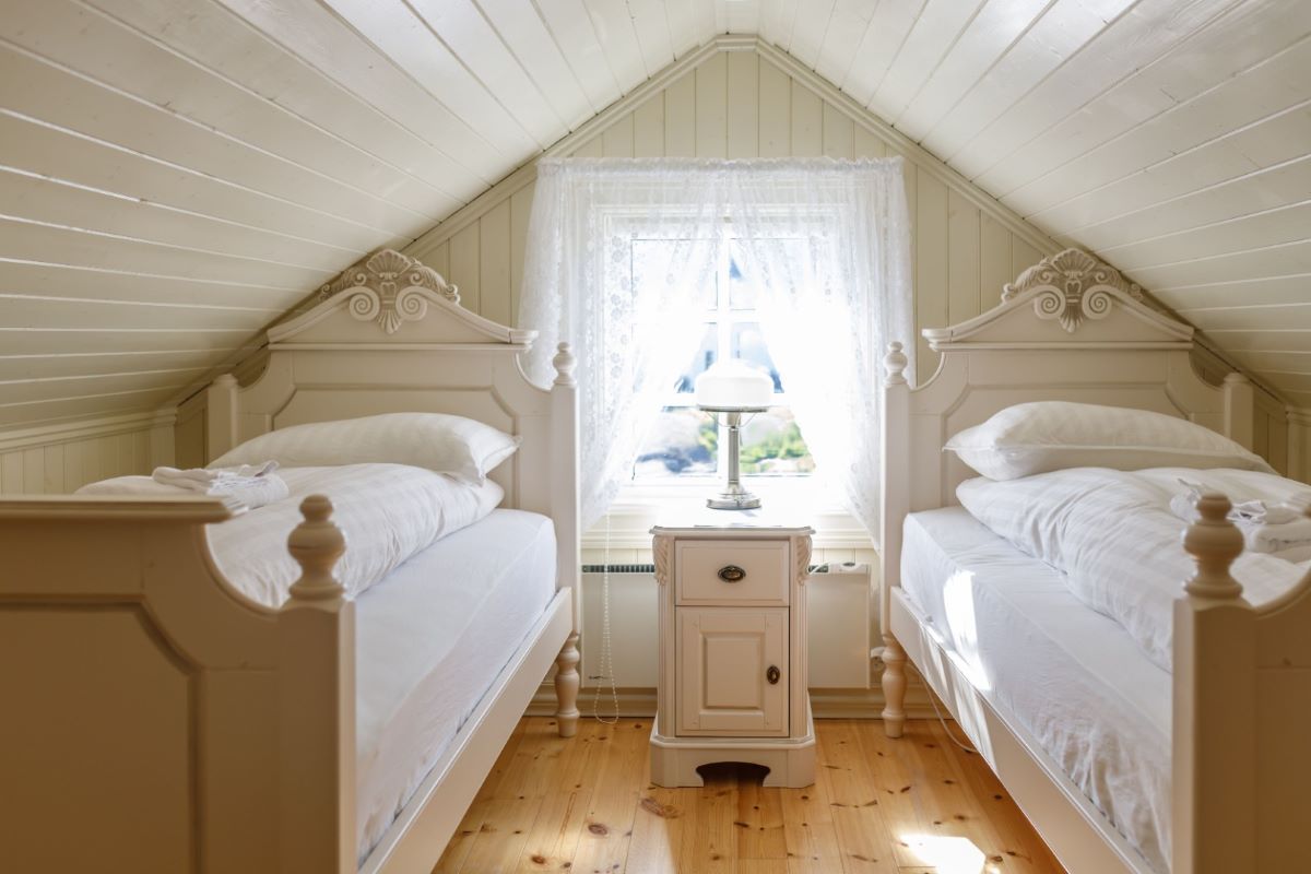 a room with two beds and a window