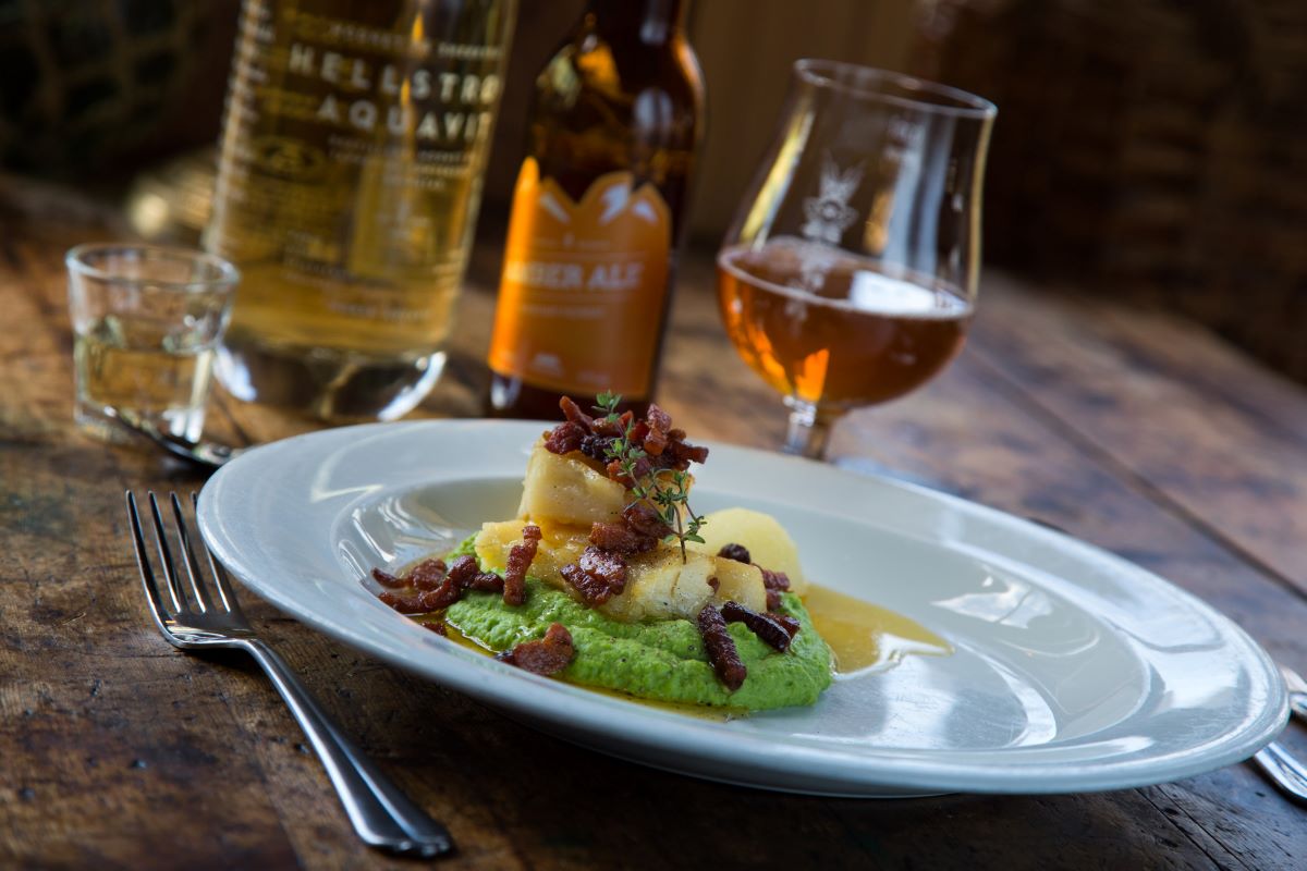 a plate of food and a glass of beer