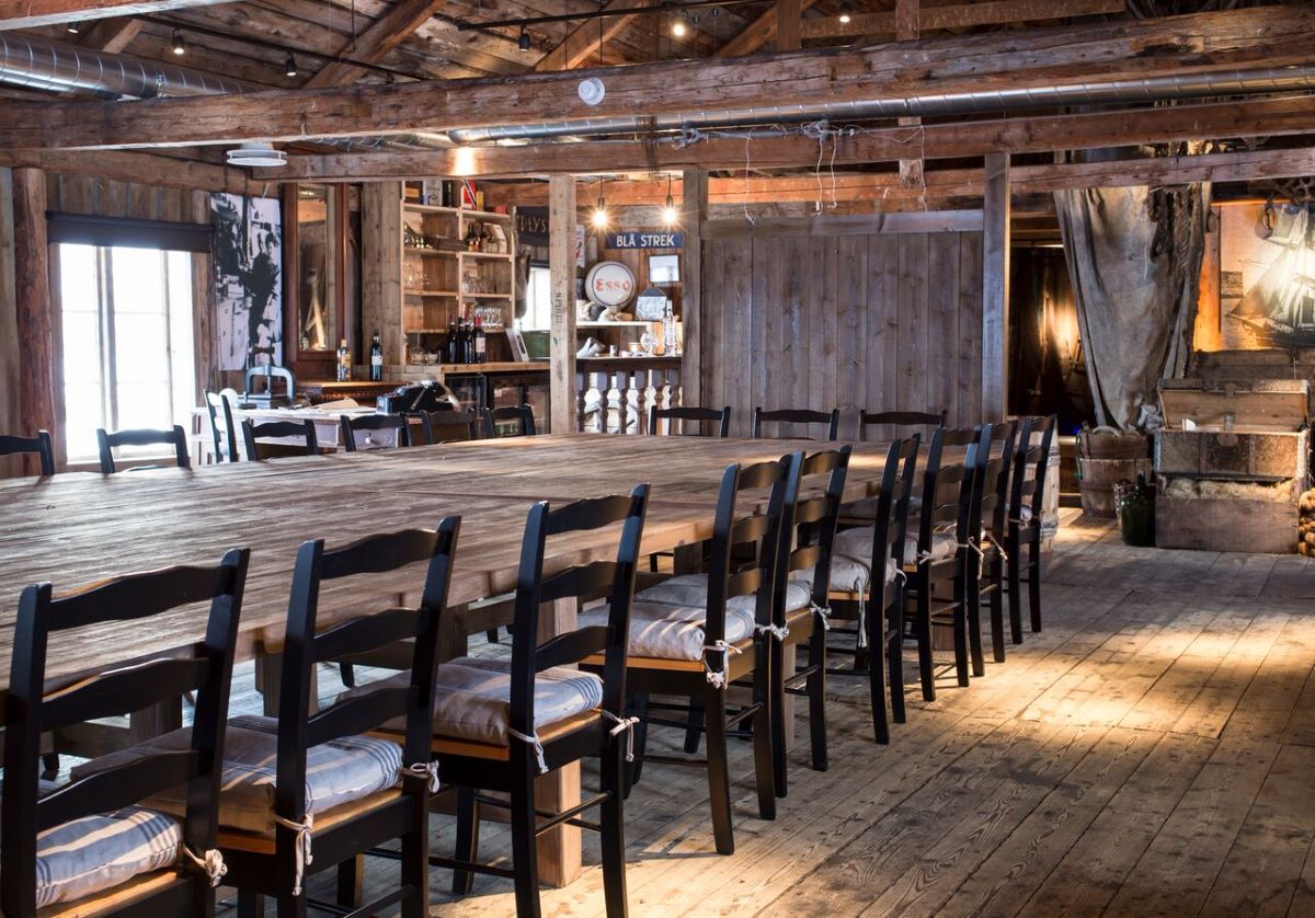a room with a large table and chairs