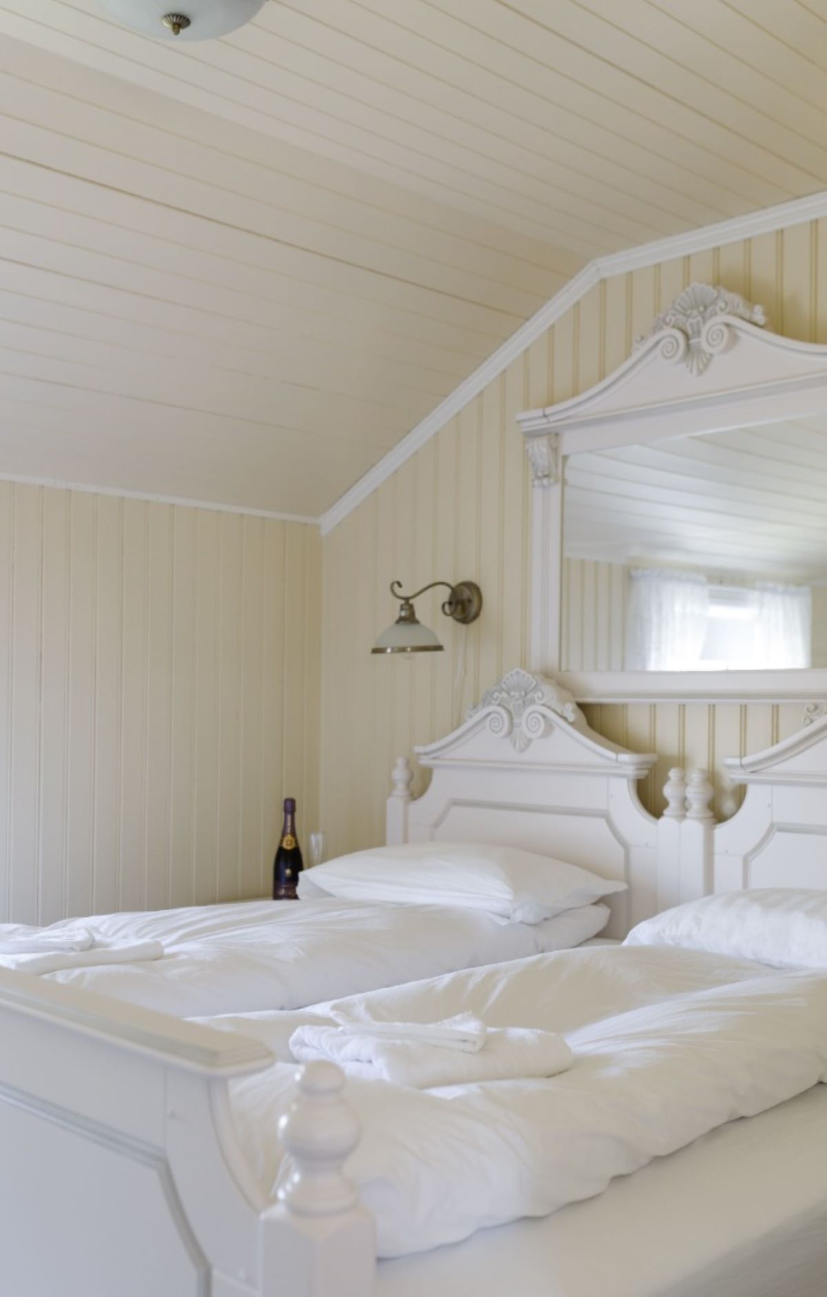 a room with two beds and a mirror