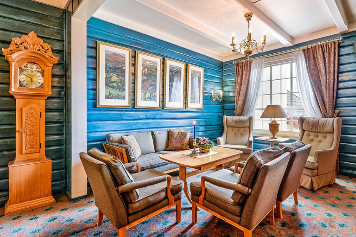 a room with a couch and chairs