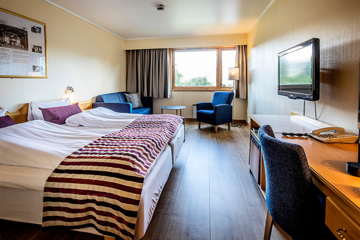 a room with a bed and a television