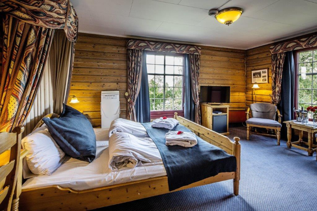 a room with a bed and a television