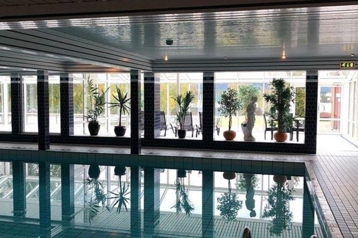 a indoor pool with plants in pots