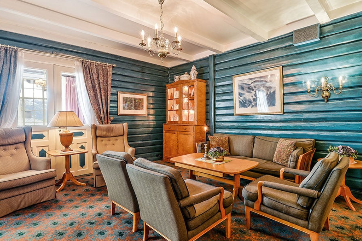 a room with a couch and chairs