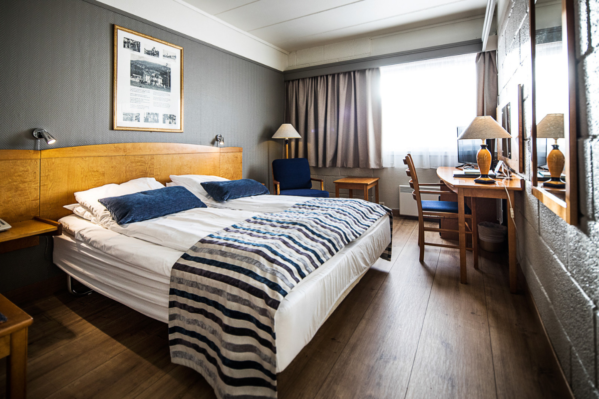 a bedroom with a bed and a desk