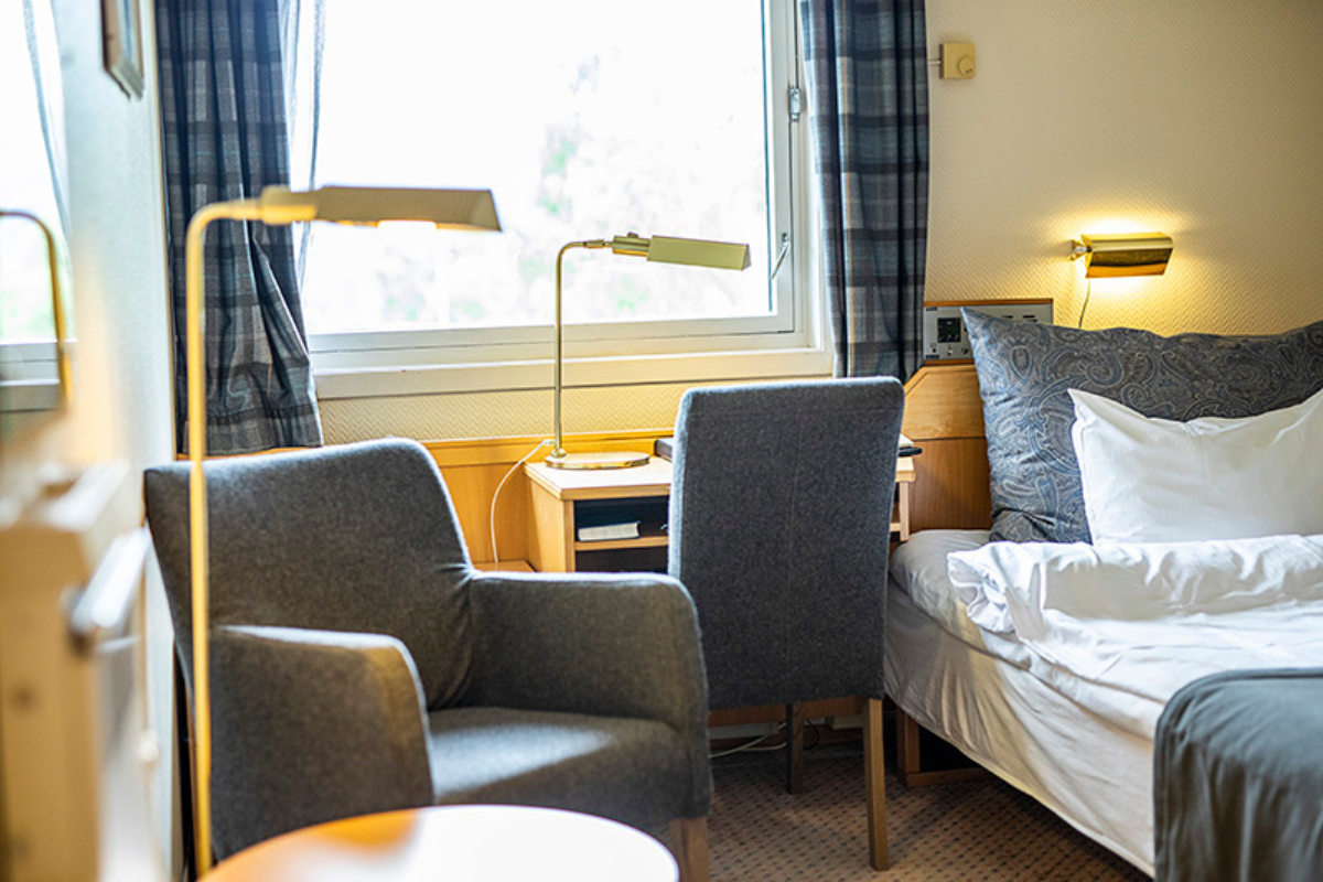 a room with a bed and a lamp