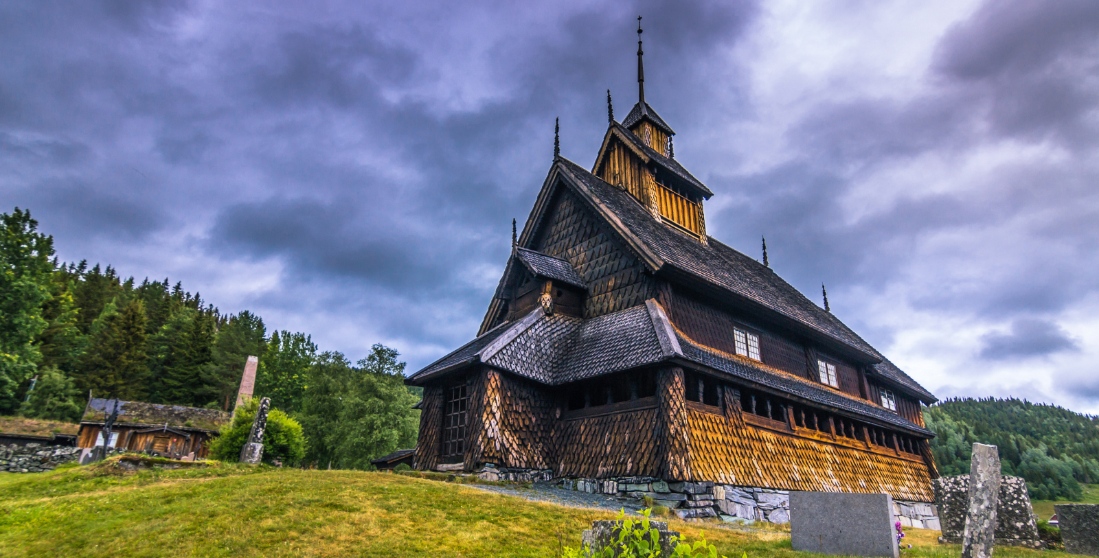 Urnes Stave Church with a steeple and grass