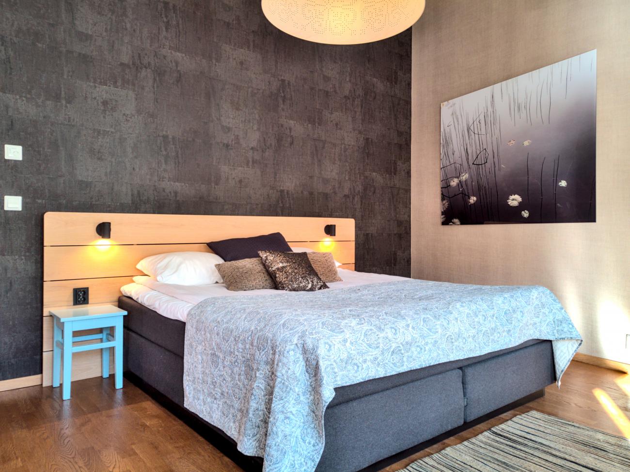 a bed with a light from the ceiling