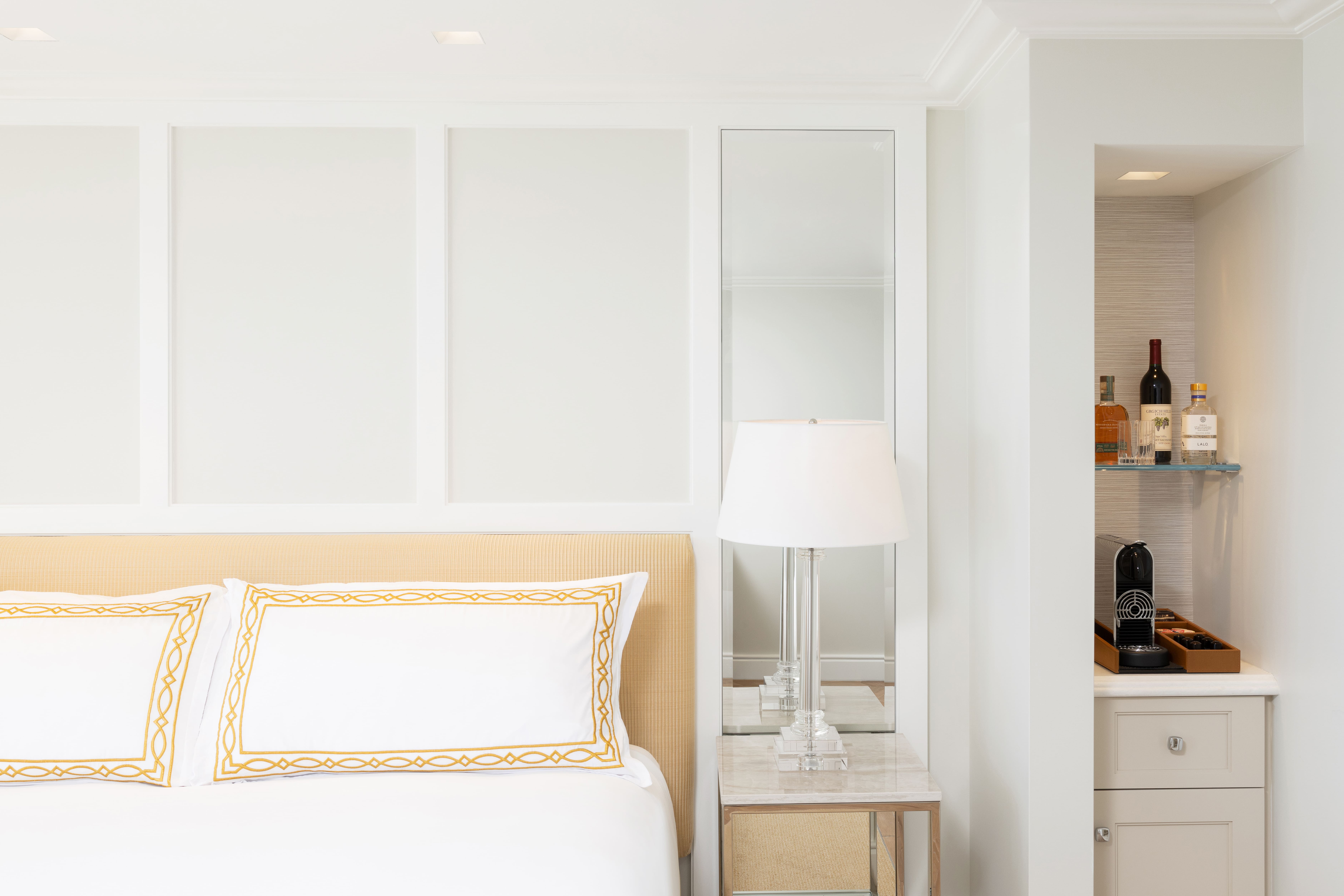 a bed with a lamp next to it