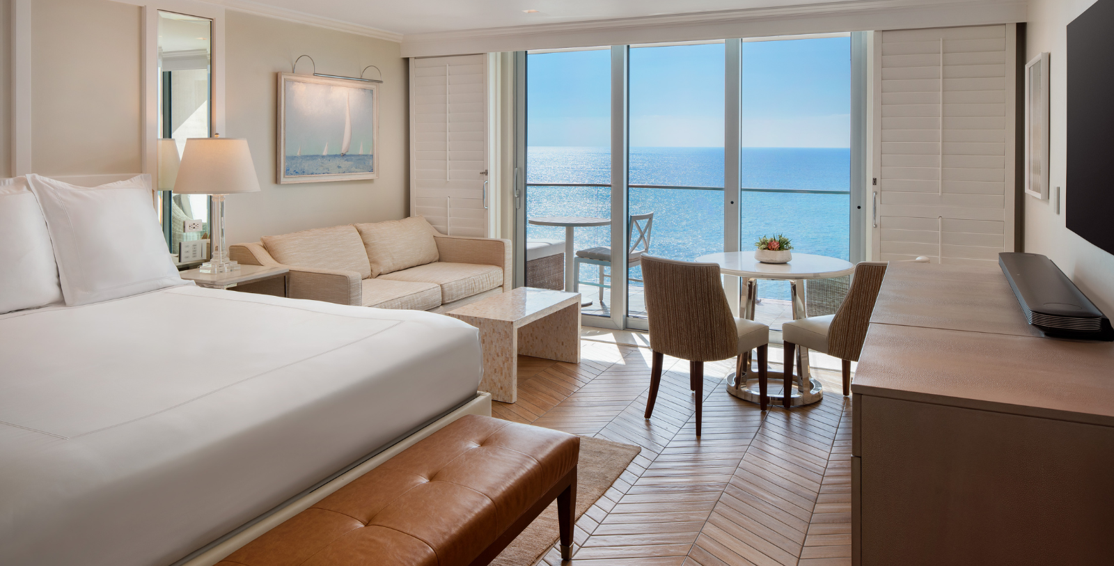 a room with a bed and a table and chairs