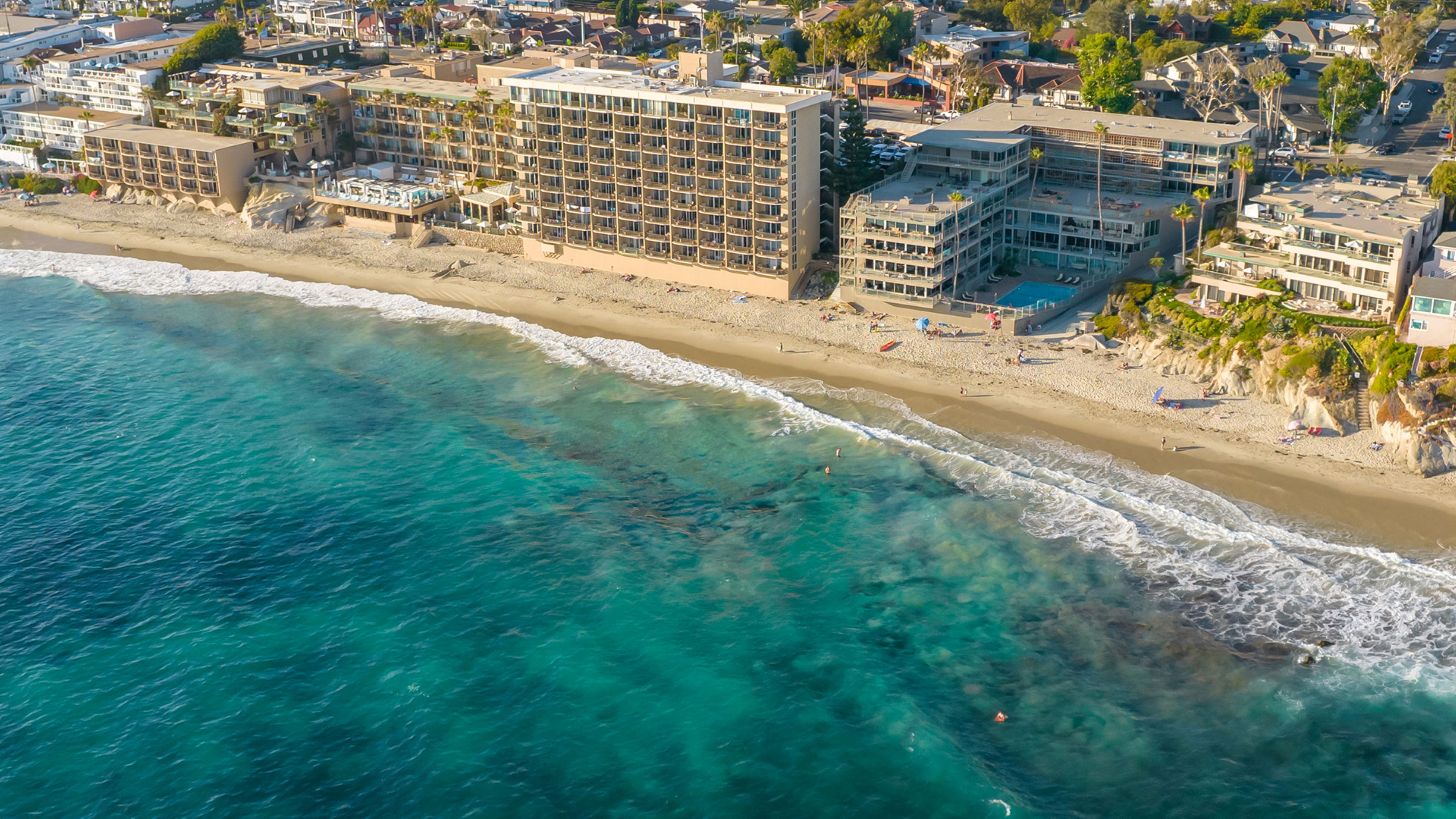 a beach with buildings and a body of water