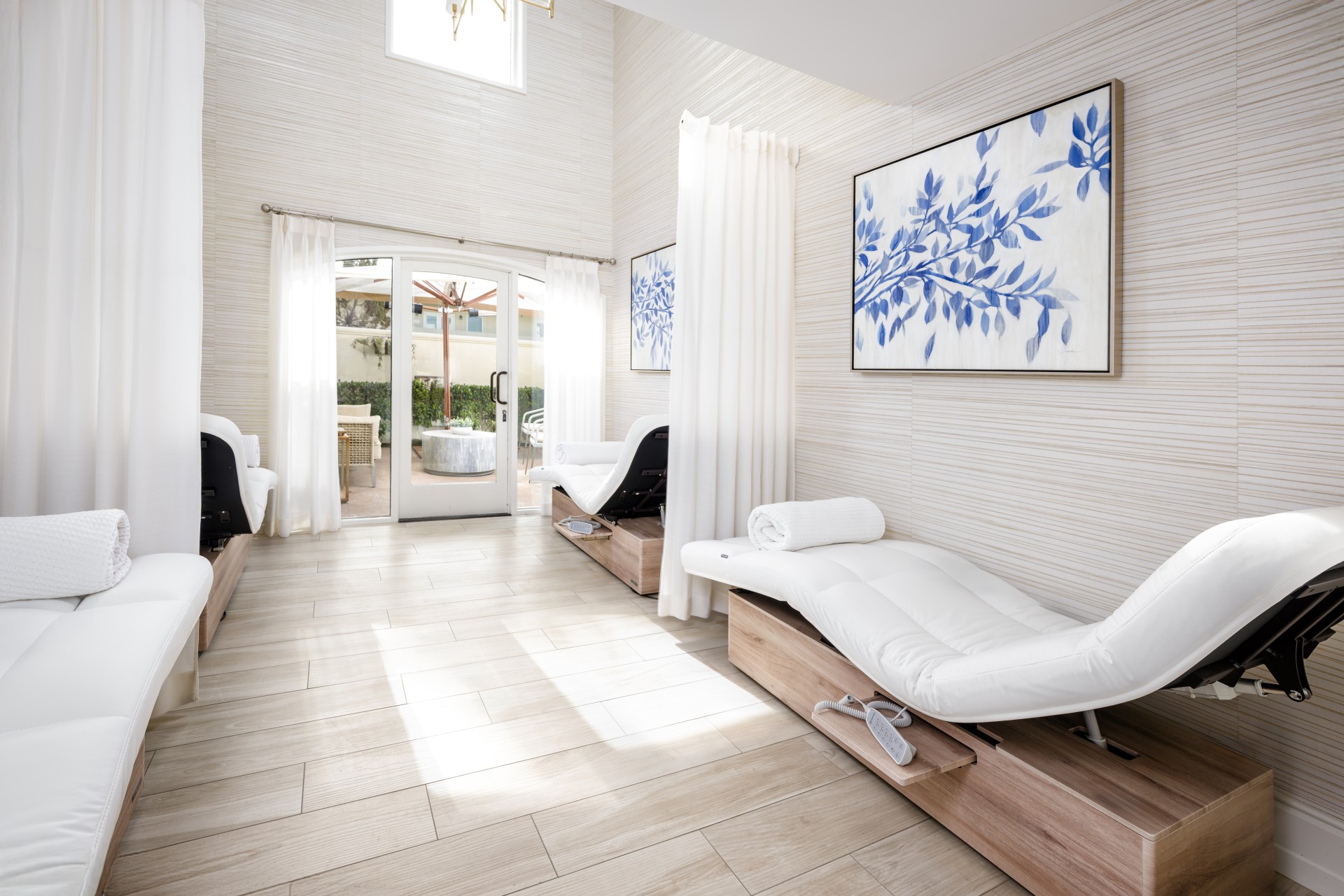 a room with white couches and a wood floor