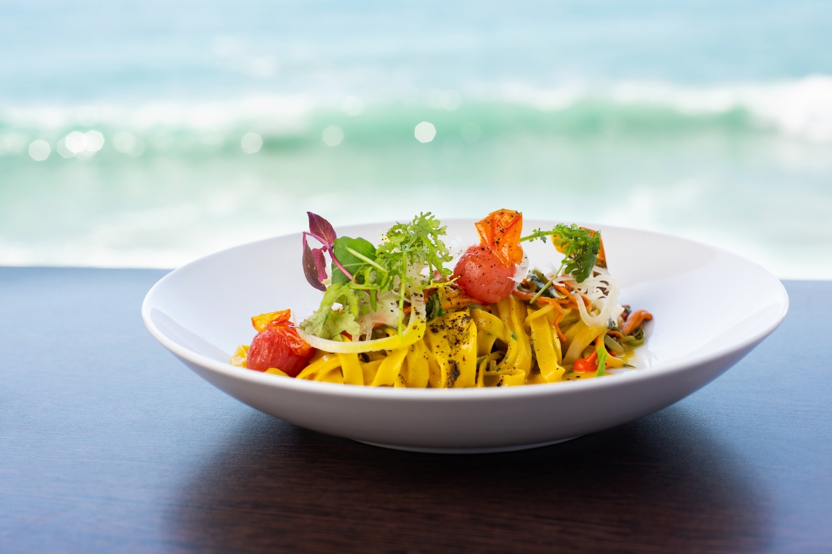 a plate of pasta with vegetables on it