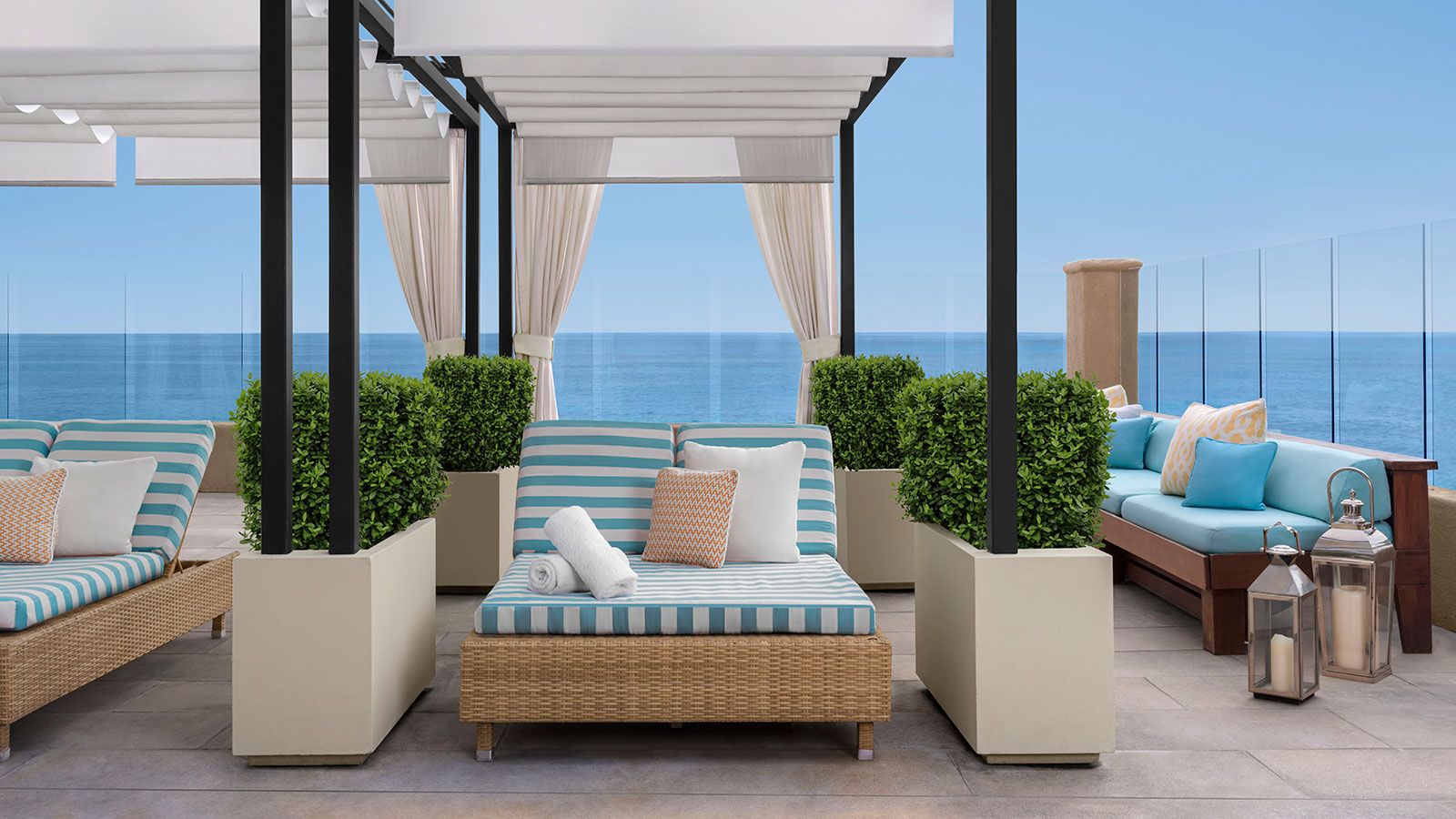 a lounge area with a view of the ocean