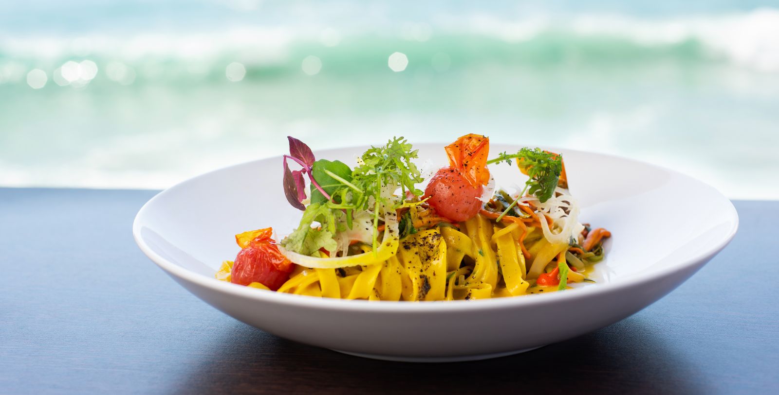 a plate of pasta with vegetables on it