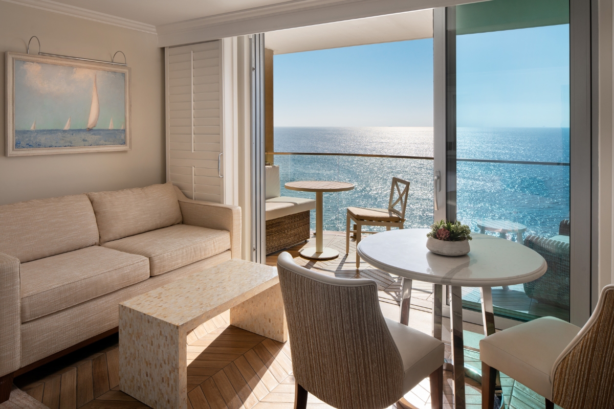 a living room with a view of the ocean