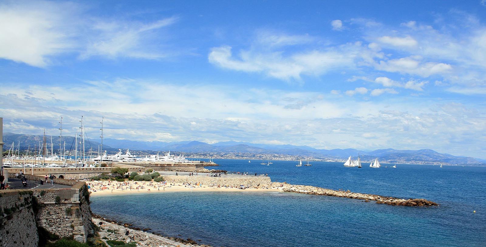 a beach with boats and a body of water