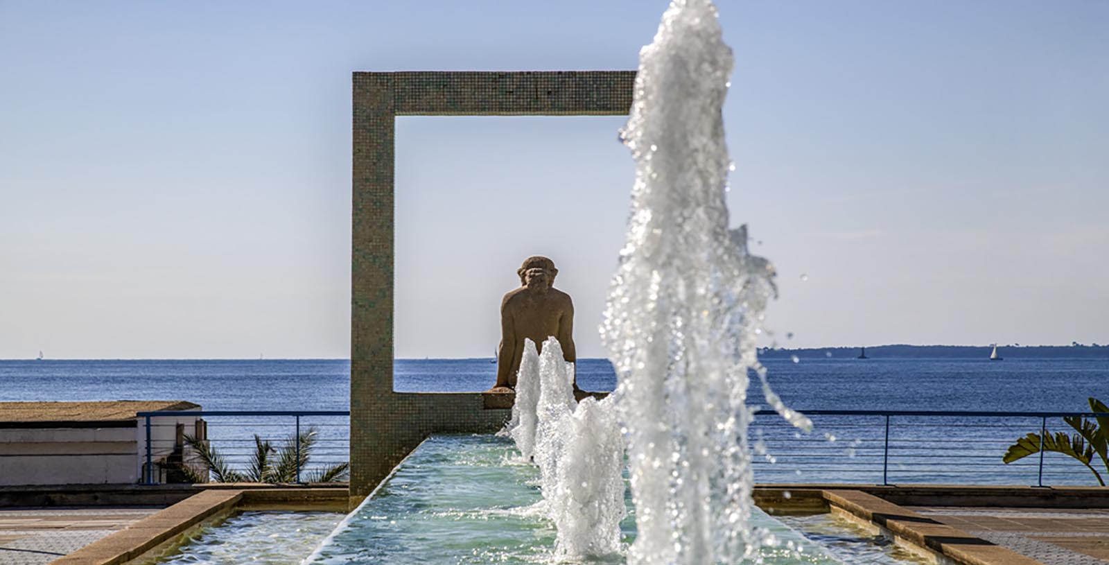 a statue of a man in a square fountain