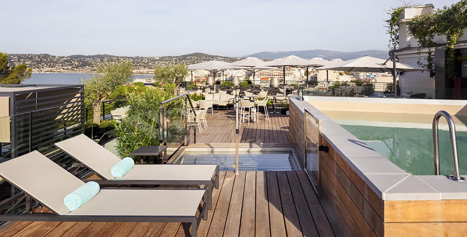 a deck with chairs and a pool