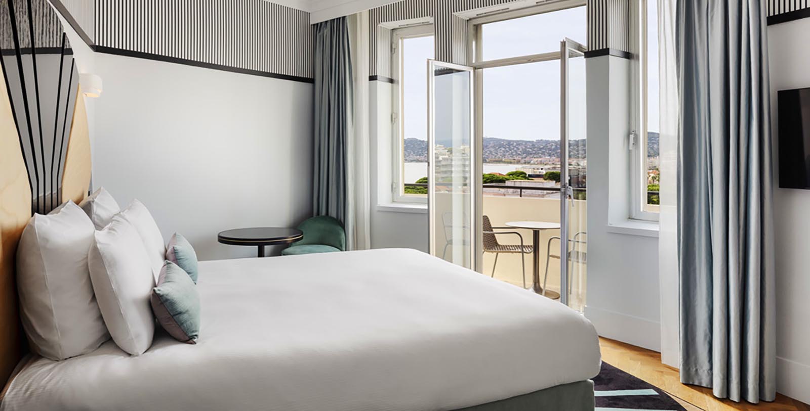 a room with a bed and a table and chairs