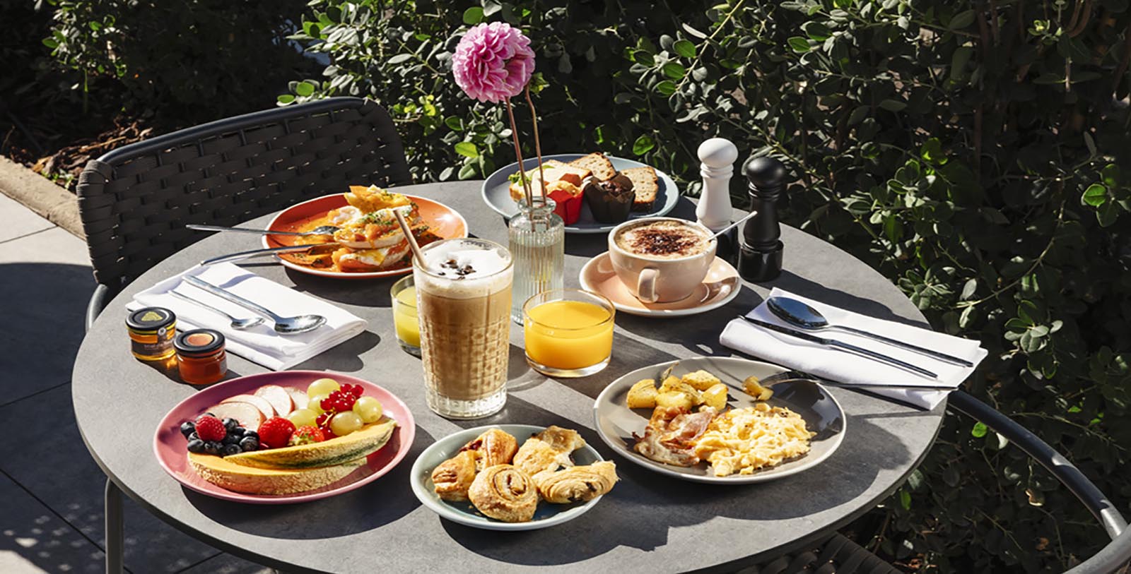 a table with plates of food and drinks