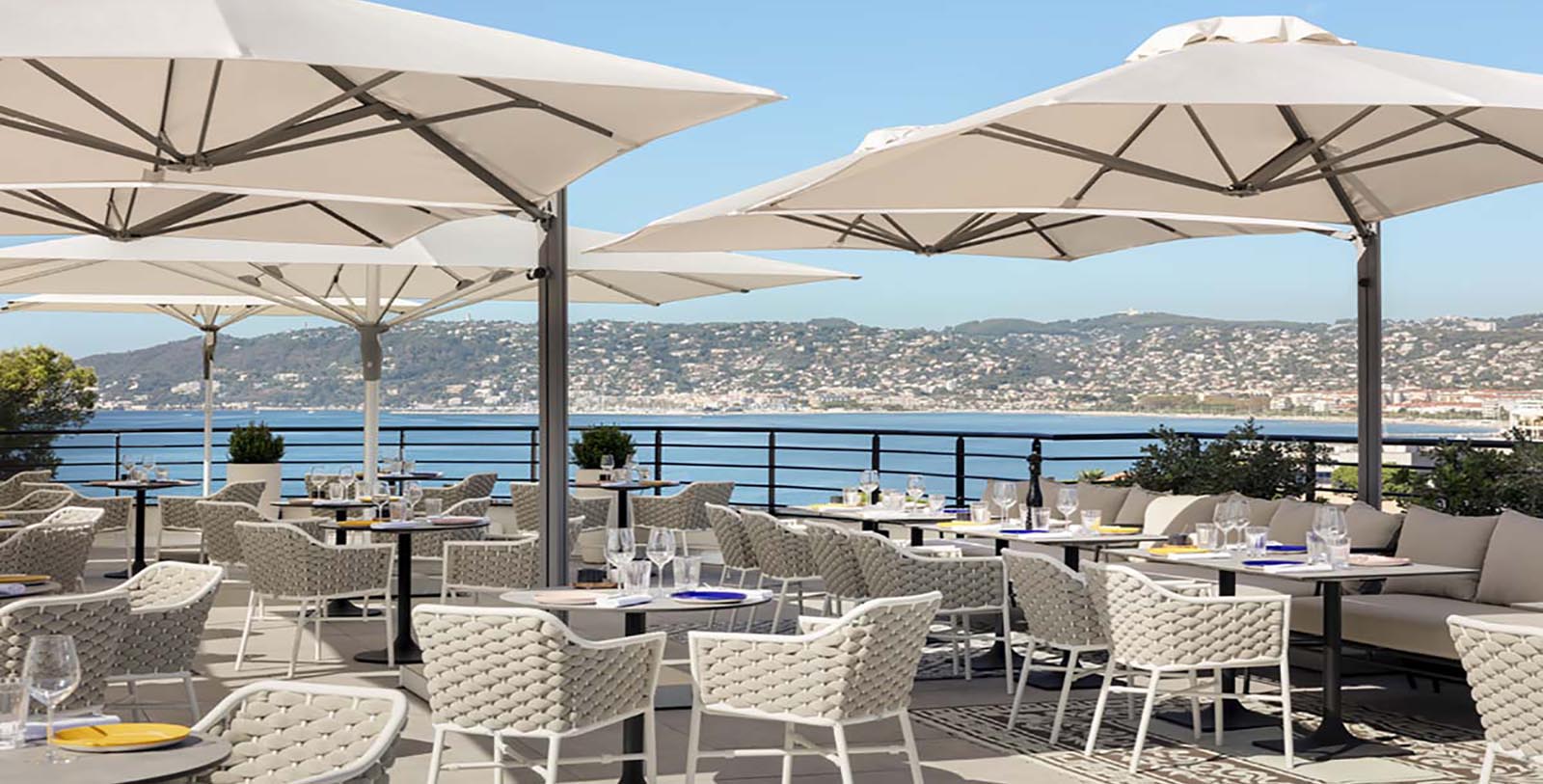 a restaurant with tables and umbrellas
