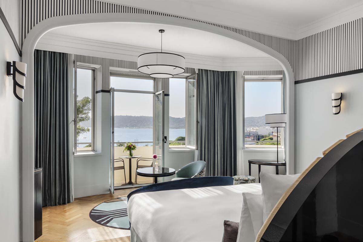 a room with a bed and a table and chairs