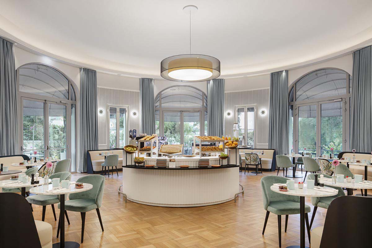 a room with a round counter and tables and chairs