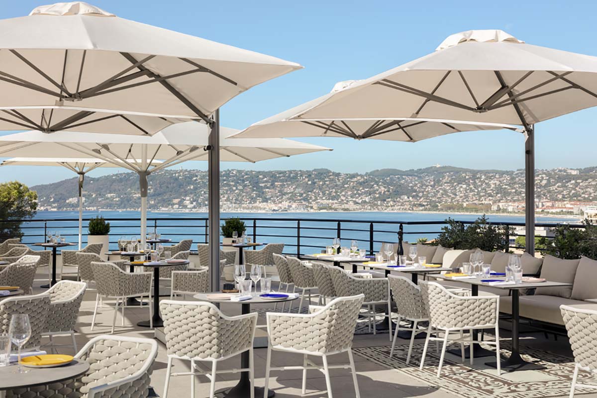 a restaurant with tables and umbrellas