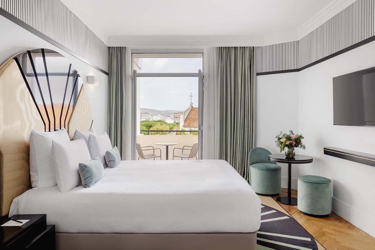 a room with a bed and a table and chairs