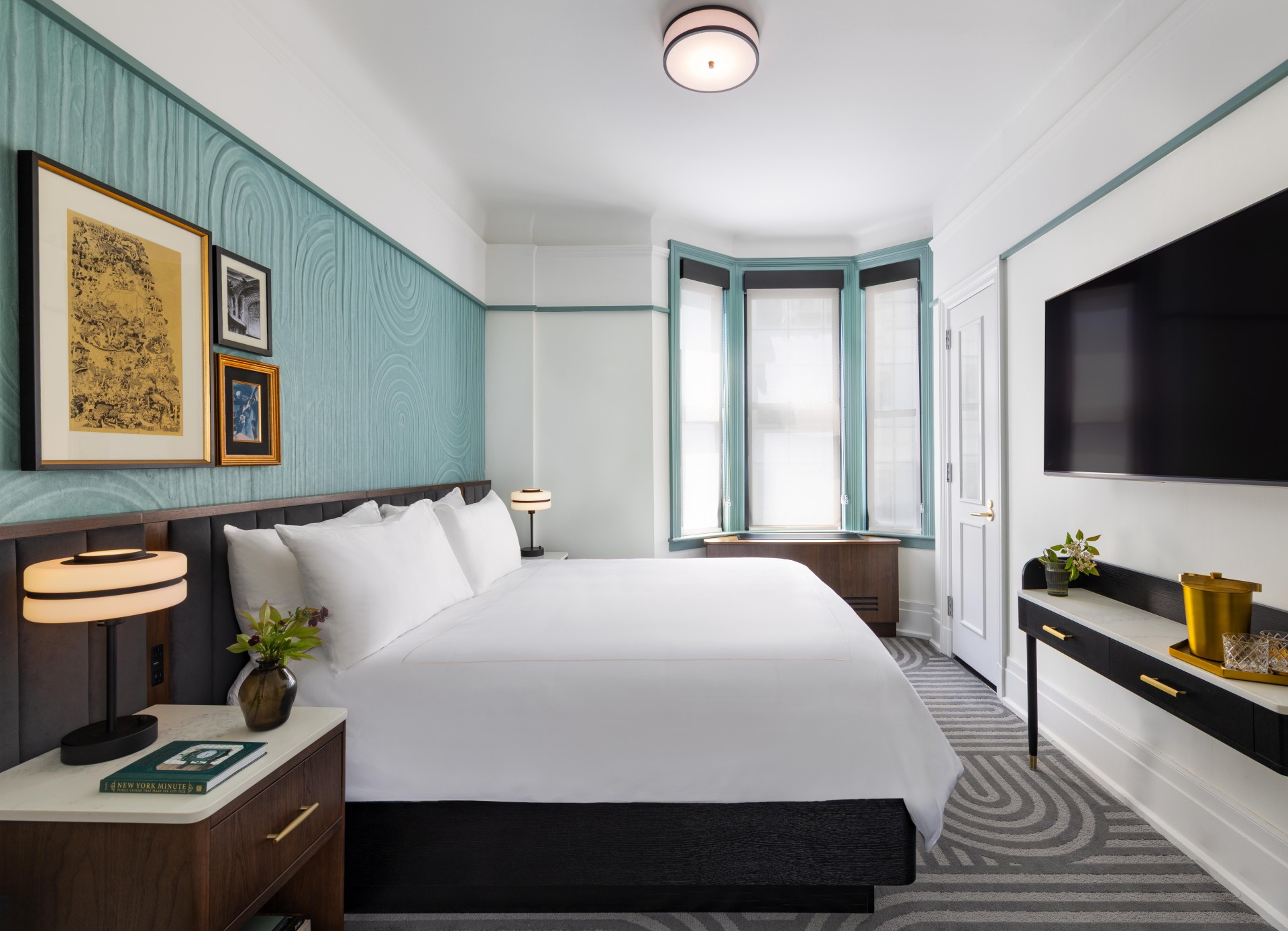 a bedroom with a bed and a tv