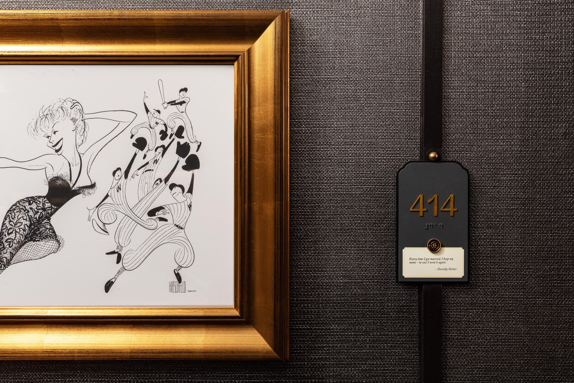 a framed picture of people in a gold frame