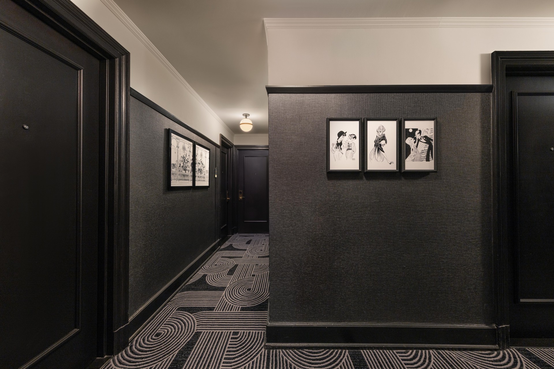 a hallway with black and white carpet
