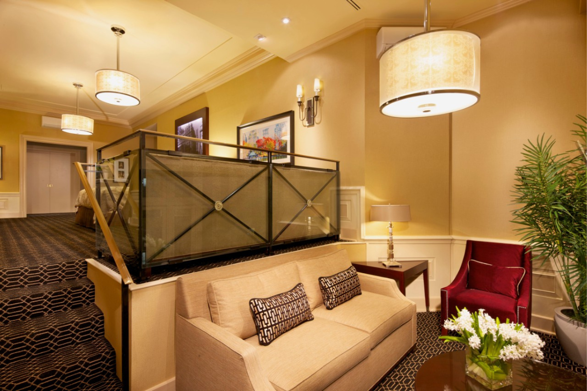 a room with a couch and a glass railing