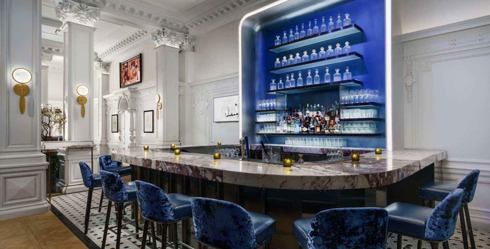 a bar with blue chairs and bottles on the shelves