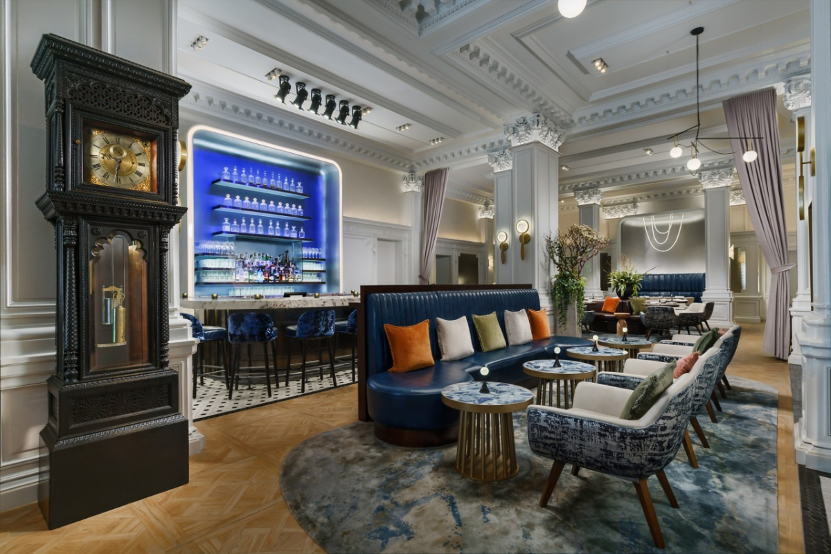 a room with a clock and tables