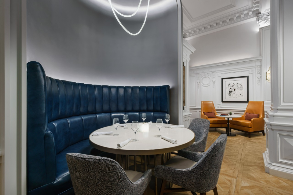 a table with a blue booth and chairs