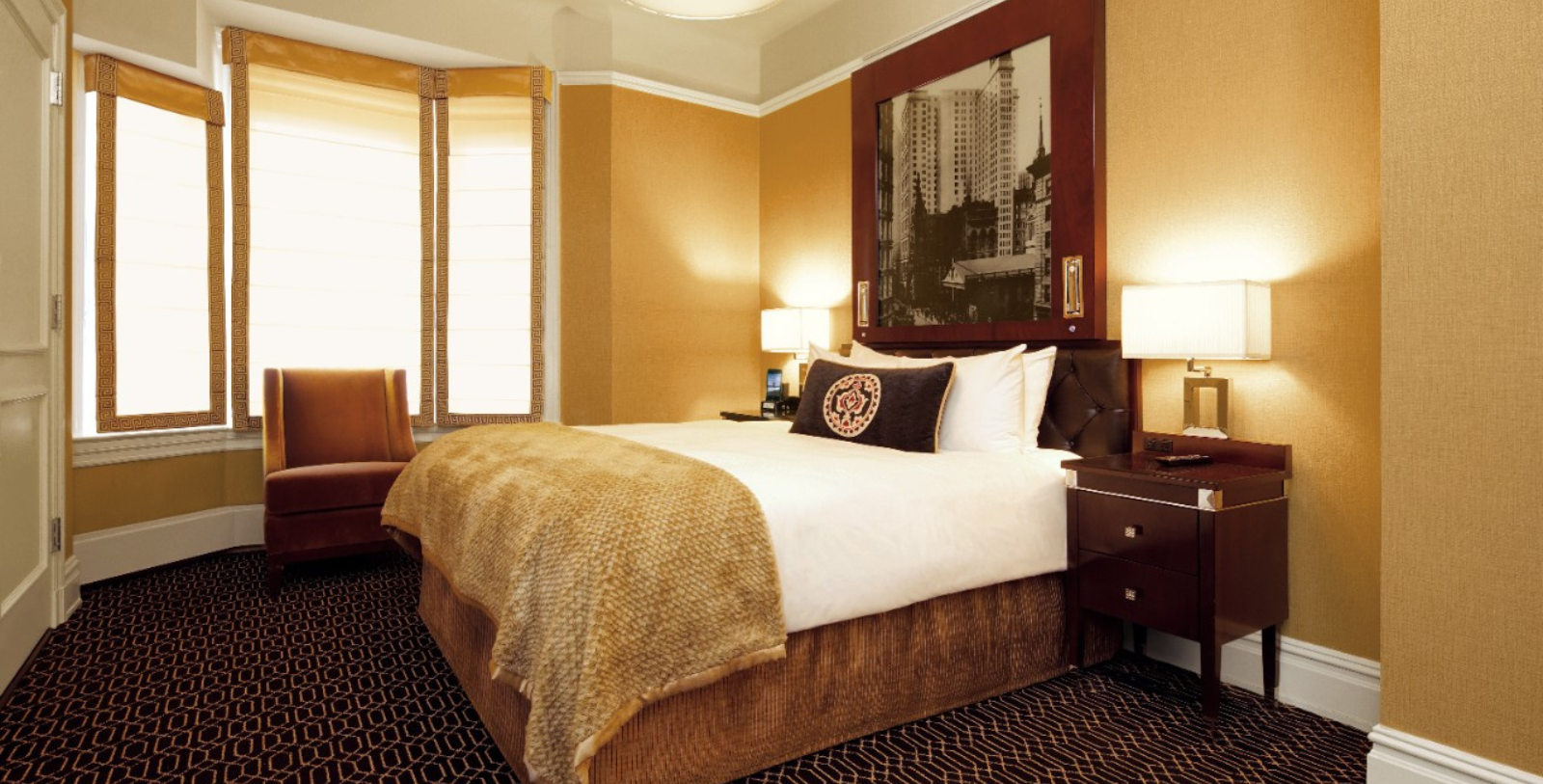 a hotel room with a bed and a picture on the wall