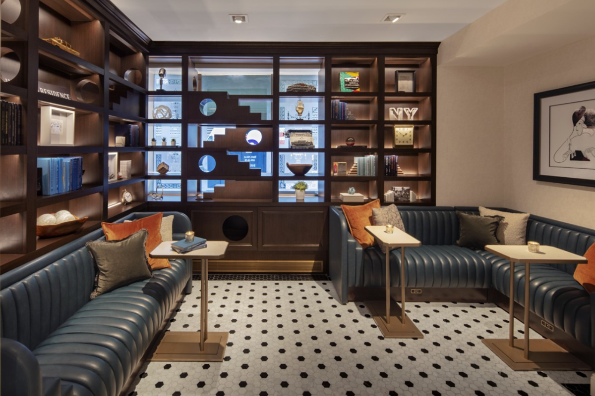 a room with a bookcase and couches