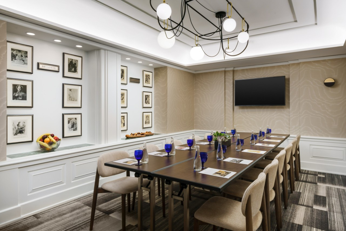 a room with a long table and chairs