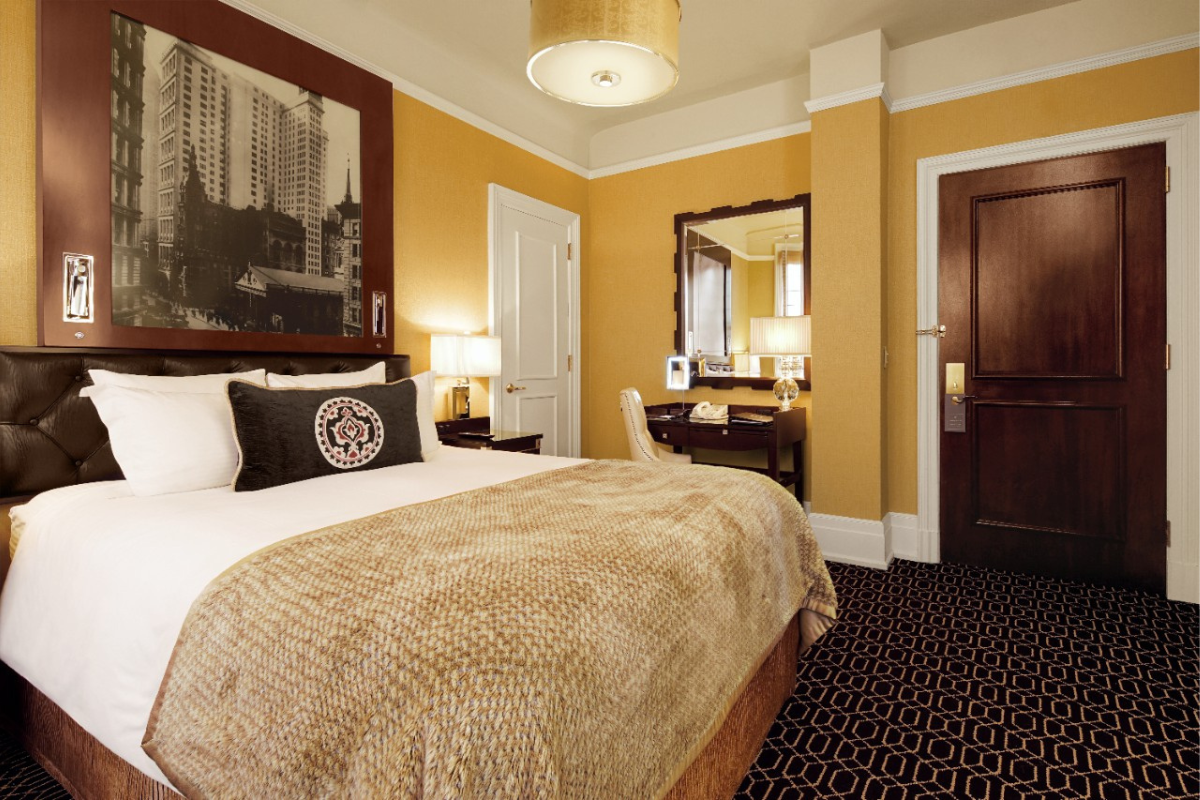 a bedroom with a bed and a mirror