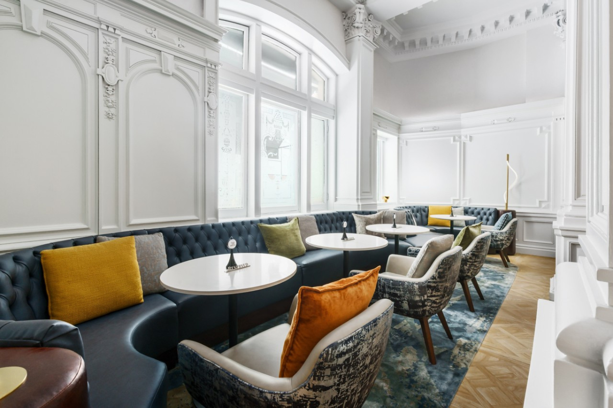 a room with a large booth and tables